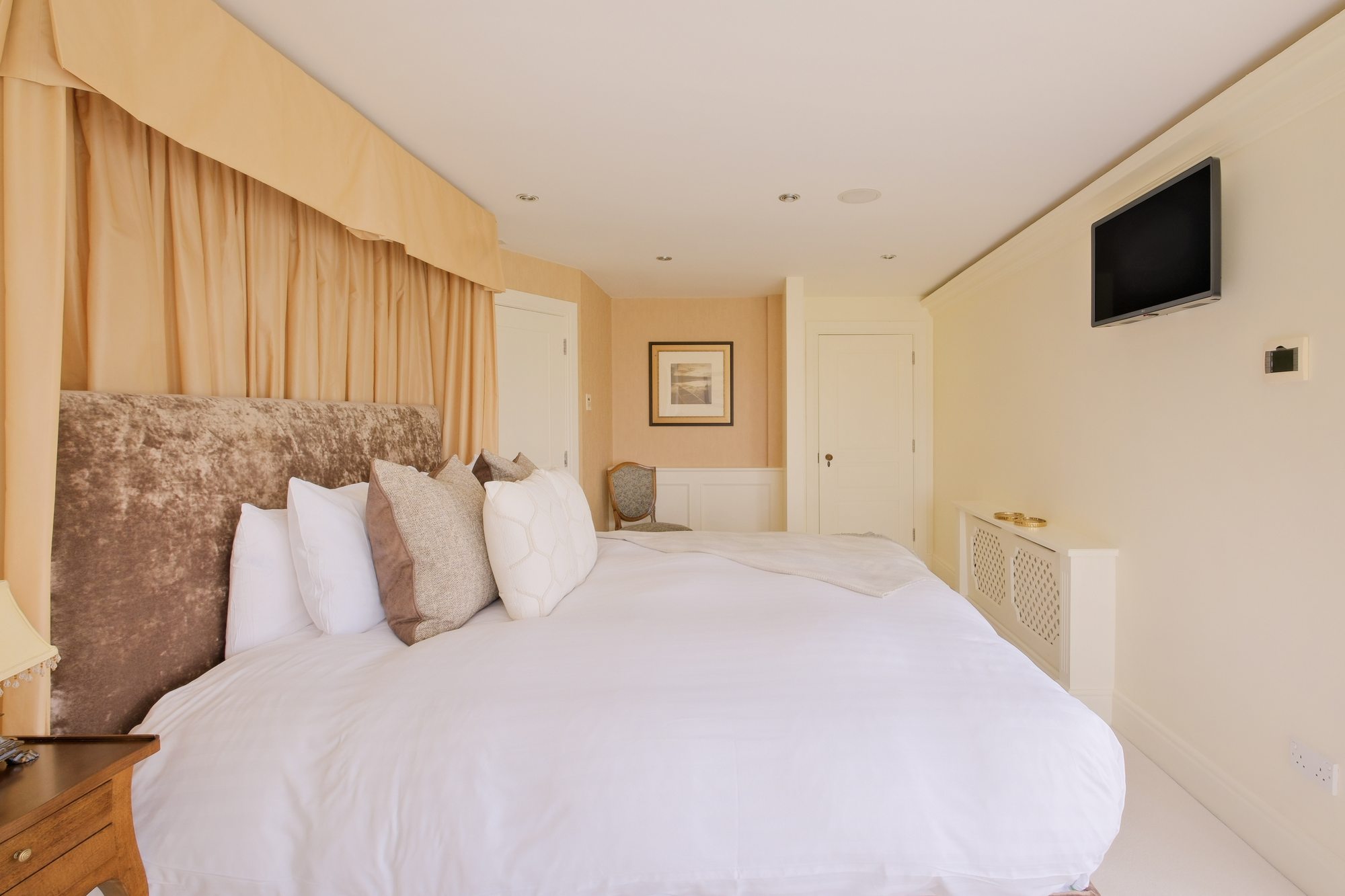 Master Suite with velvet canopy headboard and sea views