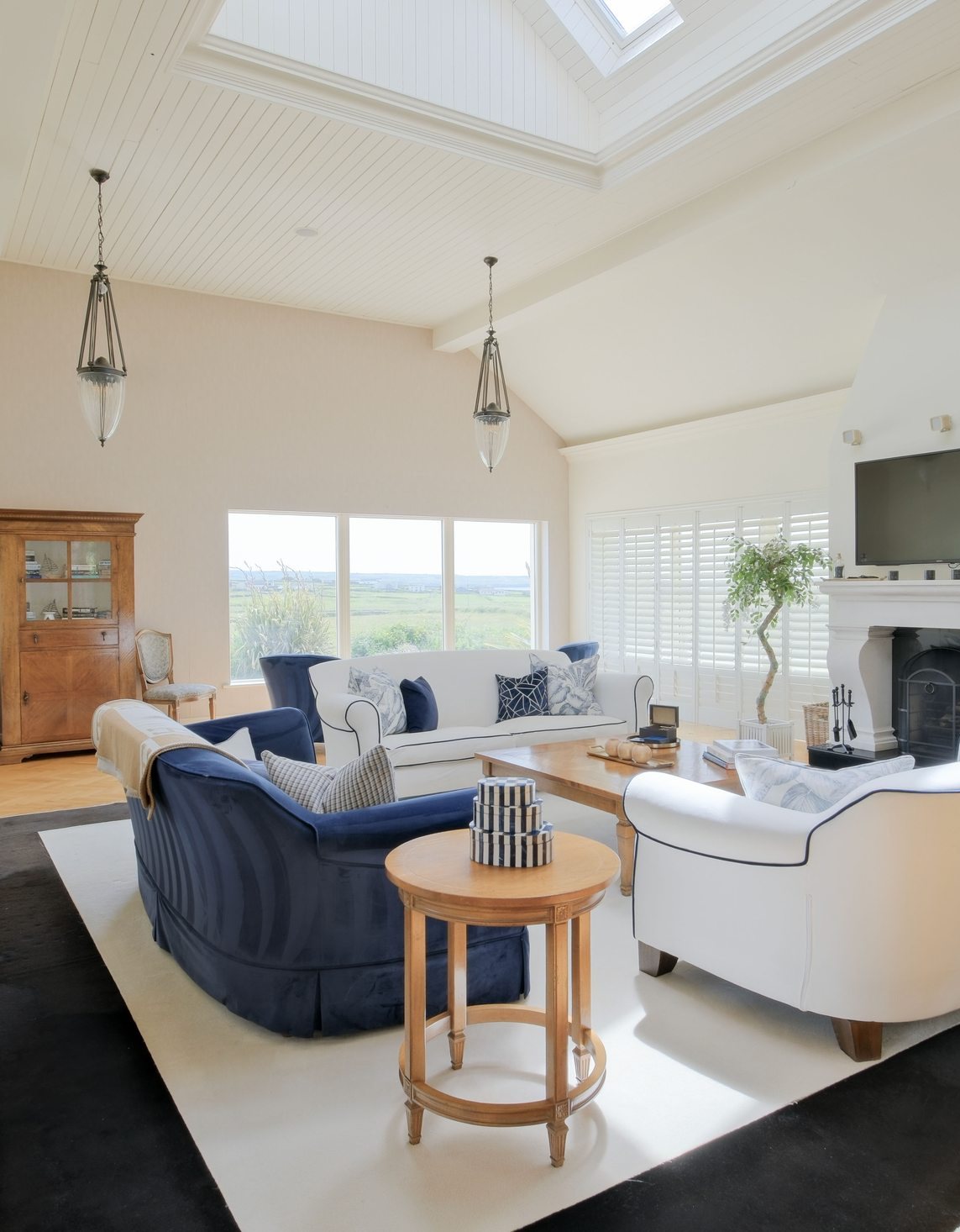 Living room with vaulted ceiling and skylights at Howard's Way