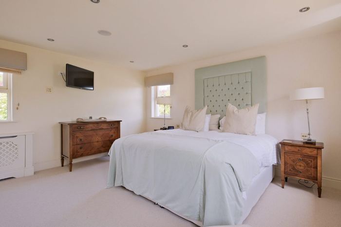 Green Suite with sage tufted headboard, super-king bed