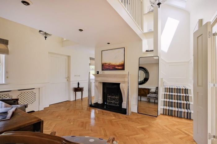 Fireplace landing with reading chairs and staircase to the upper bedrooms