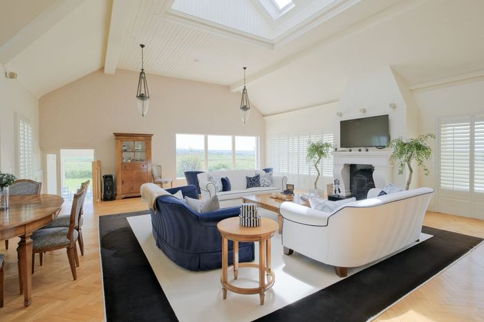 Living room with vaulted ceiling and navy and white furnishings